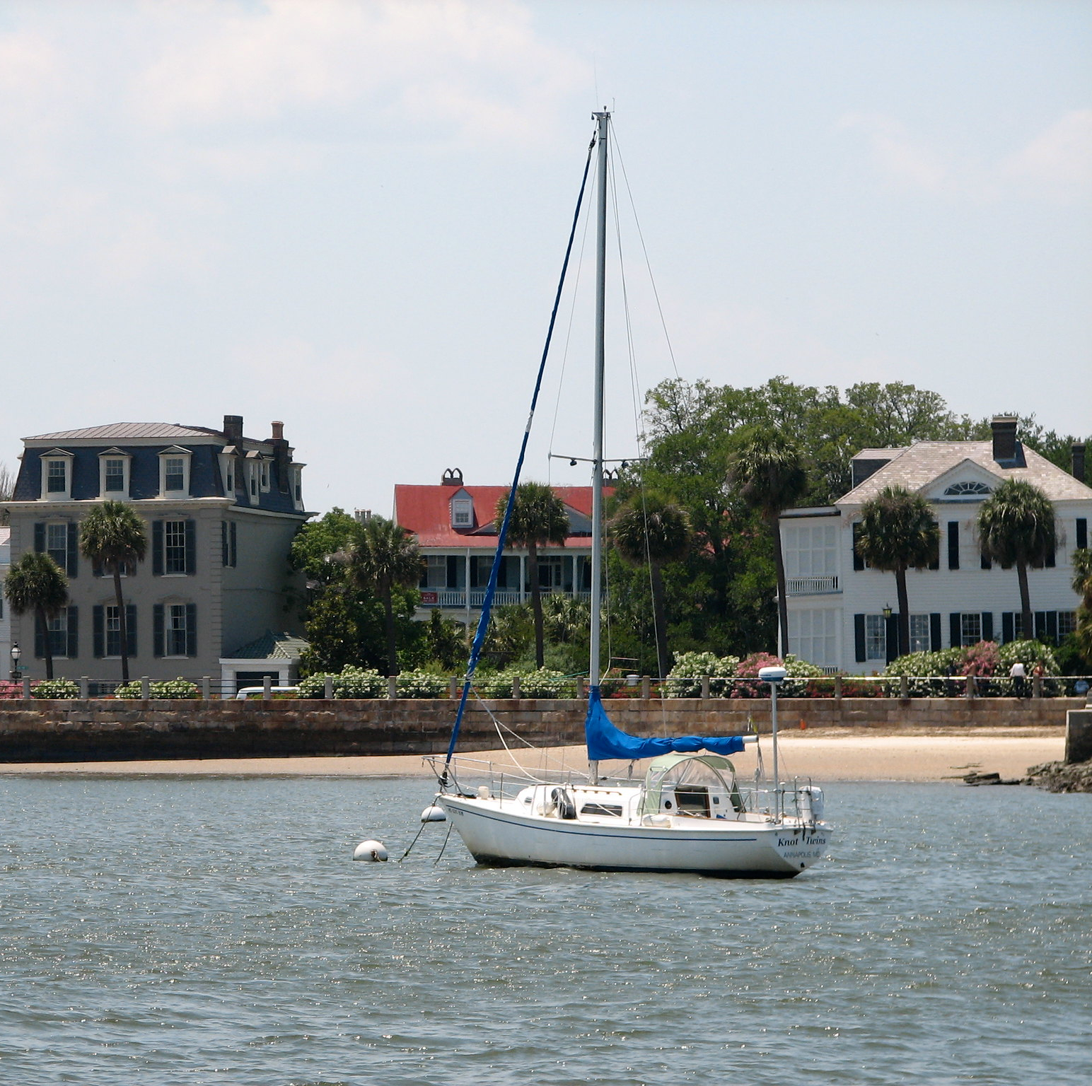 boat on a lake with buildings in the background
